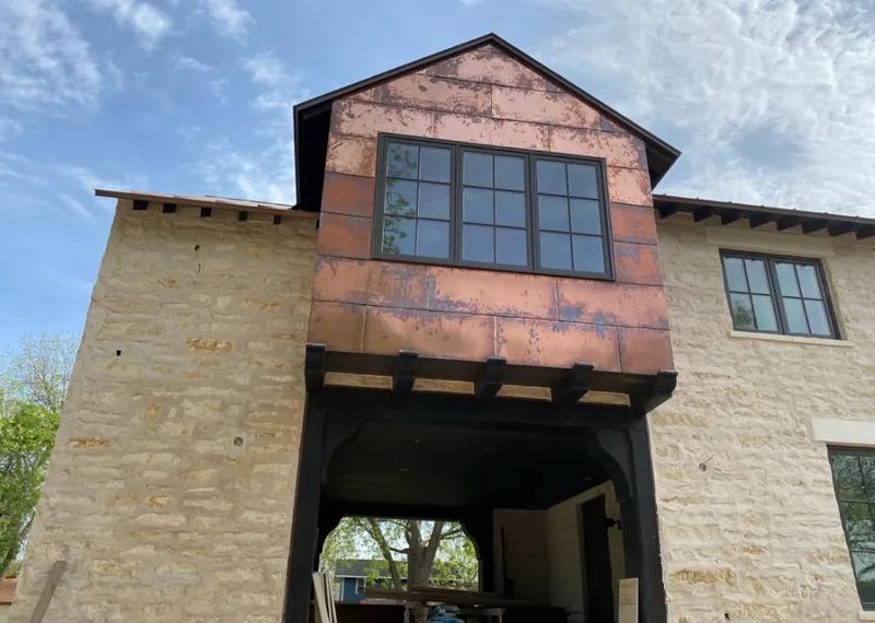 Copper metal panel facade on a stone building for Skylight Installation in Ashland